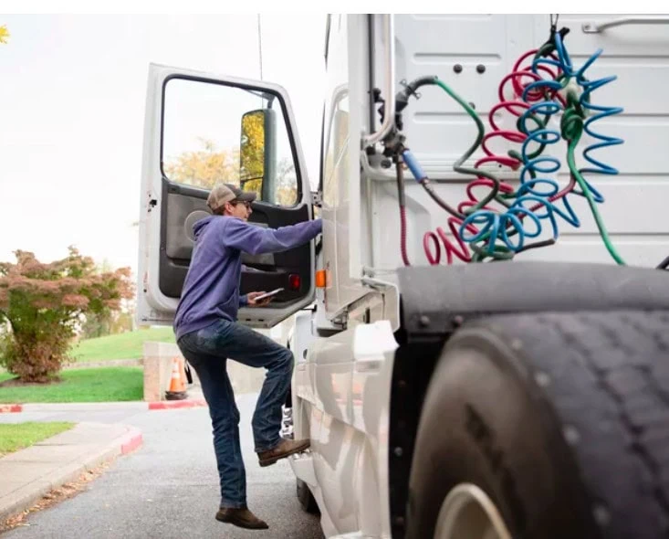 Student getting into truck